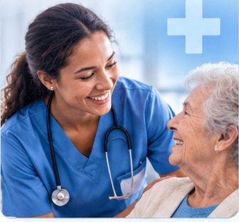 A nurse in blue scrubs with a stethoscope, smiling with an older woman she is caring for.
